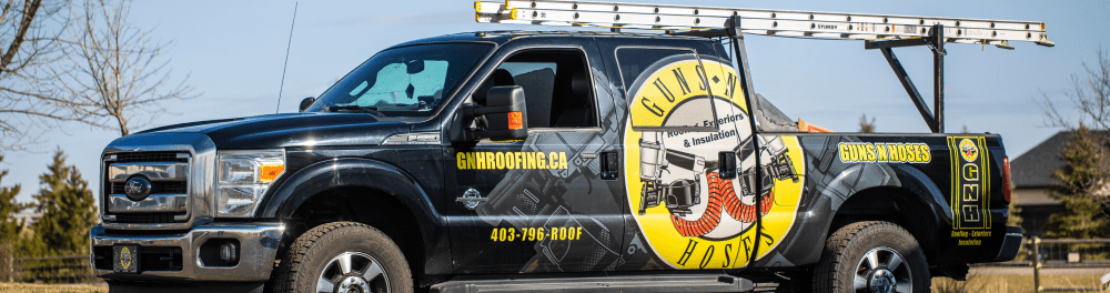 A Guns N Hoses branded truck parked outside in the sun.
