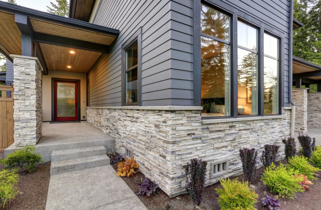 House sidings in new home showing vinyl and stone veneers.