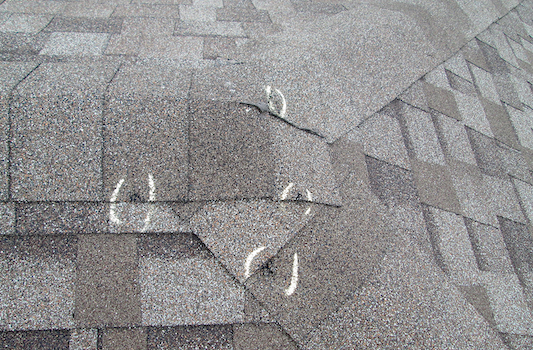 Hail damaged roof by hail inspection with identified damaged spots.