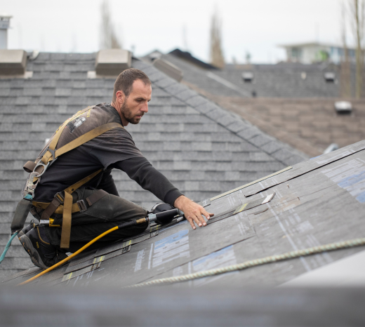 Image of a Guns N Hoses roofing expert performing repairs on a roof. The blog discusses the importance of roof maintenance and why you can trust Guns N Hoses for the job.