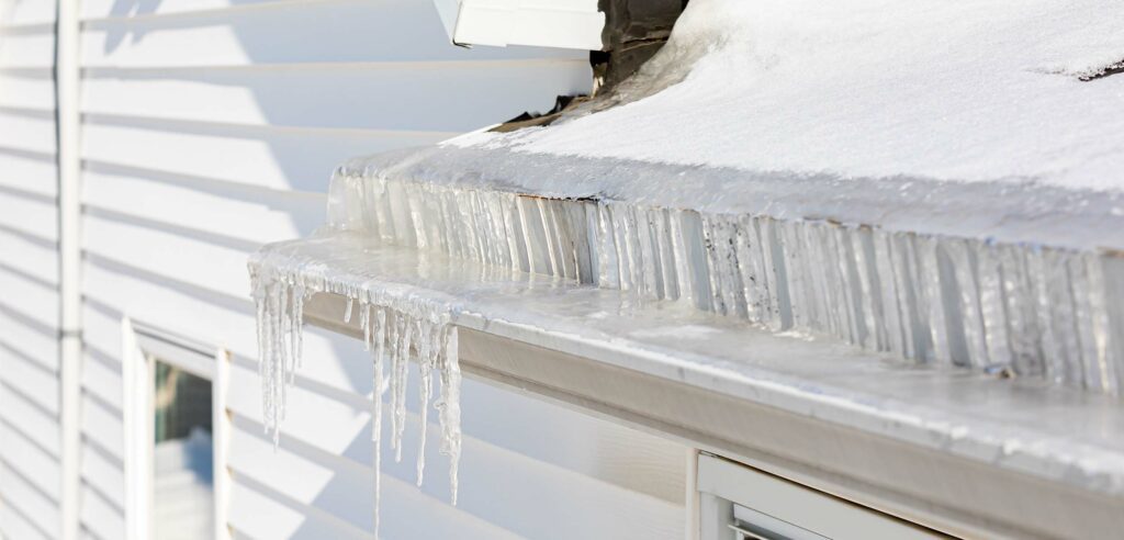 Eavestrough full of ice during winter.