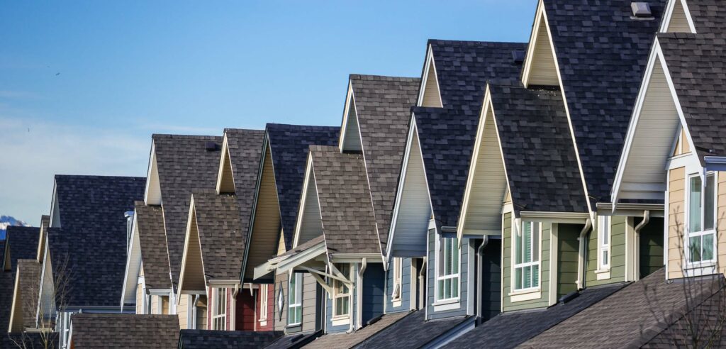 Looking down a row of houses with focus on the roofs.