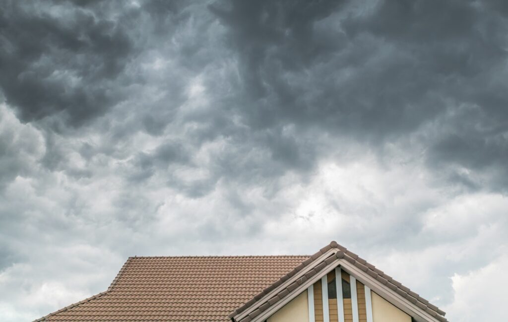 Poor conditions for DIY roof work with storm clouds over home