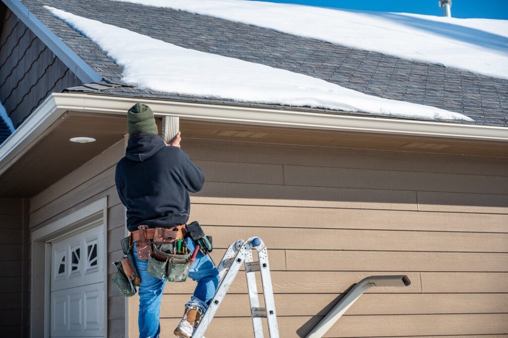 Homeowner on ladder with tool belt