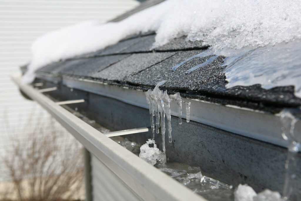 Small ice dam forming at the end of a rooftop