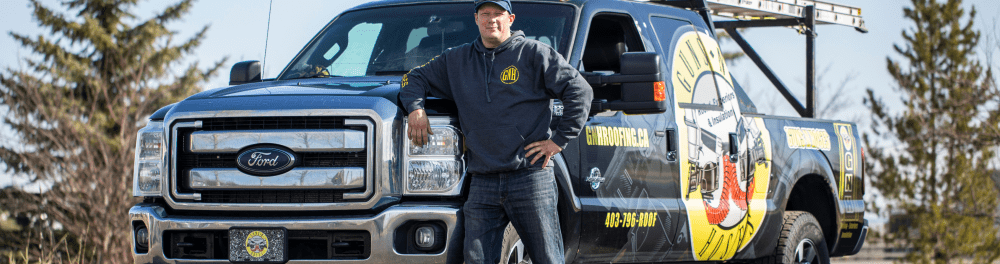 Guns N Hoses owner Keith stands next to his truck.