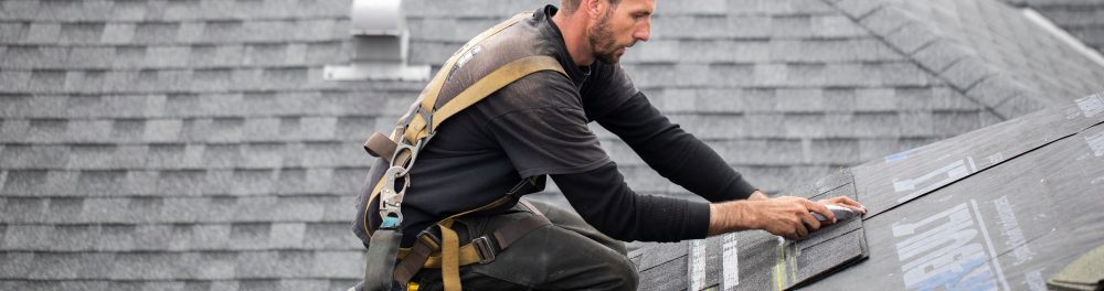 Guns N Hoses Roofer working on a roof.